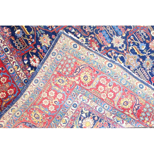 267 - Large Early 20th Century Persian Tabriz carpet, the indigo field with all-over palmette, rosette, an... 