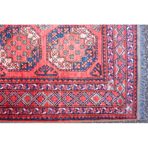 271 - Turkoman carpet, the abrashed madder field with 3 rows of 5 octagonal guls, each containing rosettes... 