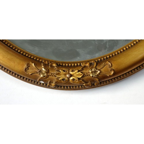 280 - Heavy gilt wood oval wall mirror with mouldings and beading, bevelled plate, 56 x 81cm.