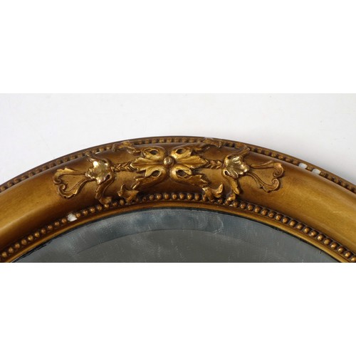 280 - Heavy gilt wood oval wall mirror with mouldings and beading, bevelled plate, 56 x 81cm.