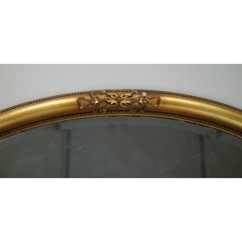 280 - Heavy gilt wood oval wall mirror with mouldings and beading, bevelled plate, 56 x 81cm.