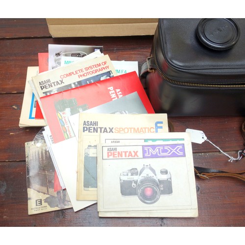 305 - Quantity of photographic related items, including instruction books, lens caps, tripods, extension t... 