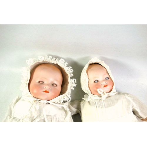 328 - Two Armand Marseille German bisque headed baby dolls, 'AM' mark to the back of the neck, with cloth ... 