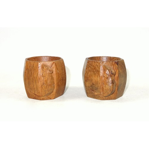 347 - Pair of Mouseman, (Robert Thompson of Kilburn), carved oak napkin rings, each octagonal and with tra... 