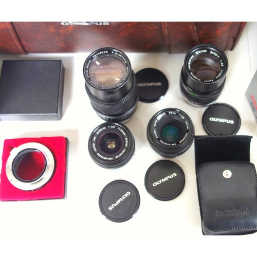 306 - 4 Olympus lenses, comprising 50mm Macro, 135mm, 28mm, and 75-150mm, and an Olympus carry case, etc. ... 