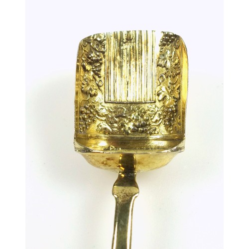 450 - George III silver gilt Fiddle Pattern caddy spoon with a fruiting vine embossed scuttle bowl, by Sam... 