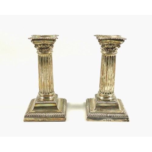 491 - Pair of Late Victorian silver candlesticks, of conventional Corinthian form, with removable nozzles,... 