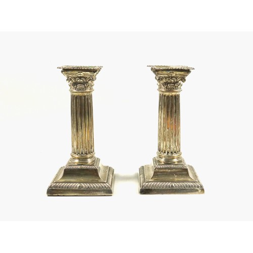 491 - Pair of Late Victorian silver candlesticks, of conventional Corinthian form, with removable nozzles,... 