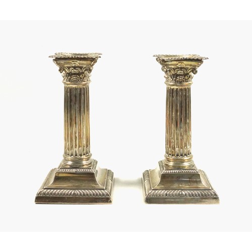 491 - Pair of Late Victorian silver candlesticks, of conventional Corinthian form, with removable nozzles,... 