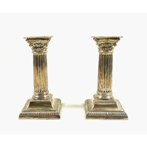 491 - Pair of Late Victorian silver candlesticks, of conventional Corinthian form, with removable nozzles,... 