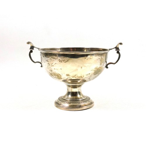 493 - George V silver pedestal bowl, with 2 lyre shaped handles, the stepped circular foot with foliate de... 