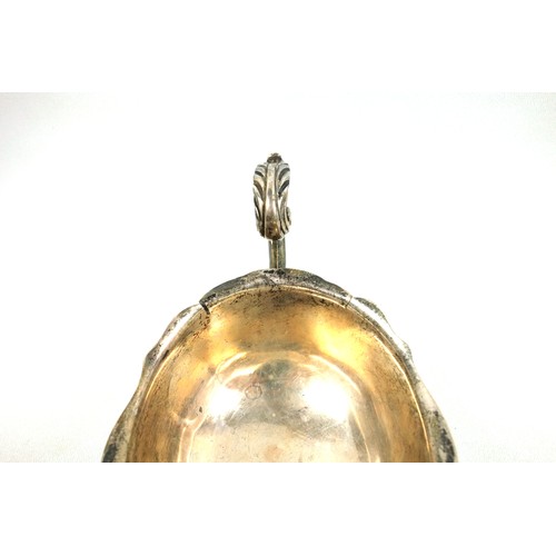 508 - George V silver sauceboat, of conventional form with a shaped rim and flying scroll handle, on 3 hoo... 