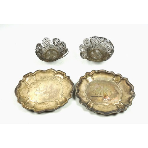 513 - Pair of Eastern white metal lobed dishes, each with a floral motif, on 4 ball feet, W.17.5cm, and a ... 