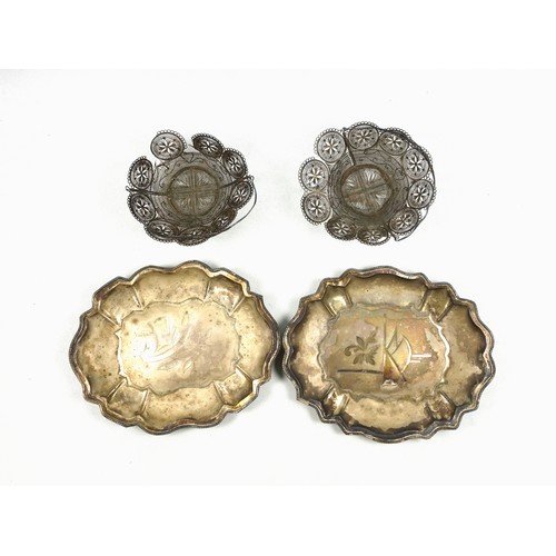 513 - Pair of Eastern white metal lobed dishes, each with a floral motif, on 4 ball feet, W.17.5cm, and a ... 