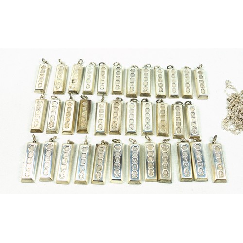 519 - 35 Britannia silver ingot pendants, by Carrs of Sheffield, 1977, H.4.7cm approx., 1110grs; and 25 ch... 