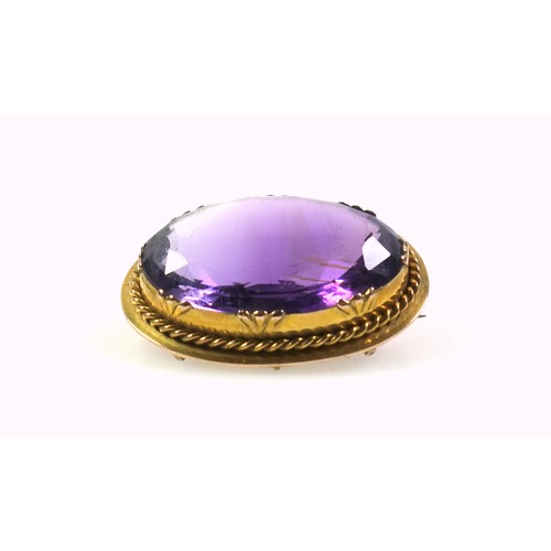 536 - A late Victorian gilt metal and amethyst faceted cabochon brooch, width 3.5cm, in a box. (2)