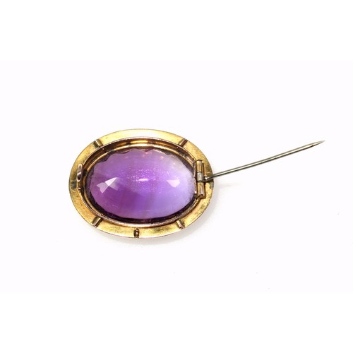 536 - A late Victorian gilt metal and amethyst faceted cabochon brooch, width 3.5cm, in a box. (2)