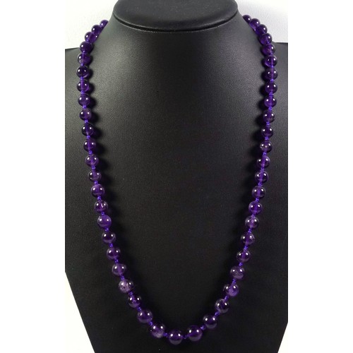 537 - An amethyst necklace with a white metal clasp stamped silver, length 67cm, the beads are graduated f... 