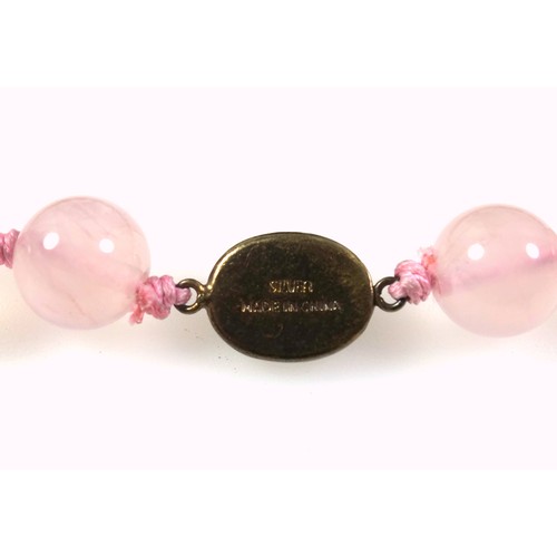 538 - A rose quartz necklace with a gilt white metal clasp stamped silver, length 62.5cm, the beads are 1.... 