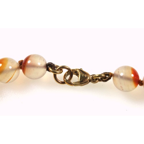 538 - A rose quartz necklace with a gilt white metal clasp stamped silver, length 62.5cm, the beads are 1.... 