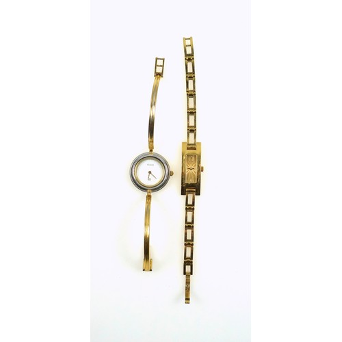 543 - A Lady's Gucci gilt metal watch, the rectangular guilloché dial with two baton hour markers, integra... 