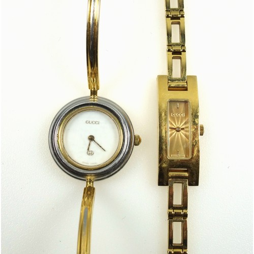 543 - A Lady's Gucci gilt metal watch, the rectangular guilloché dial with two baton hour markers, integra... 