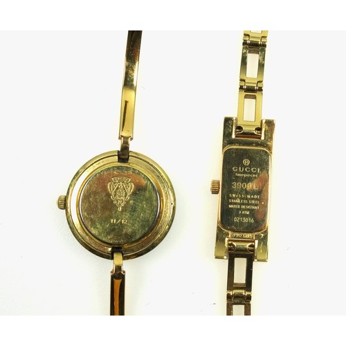 543 - A Lady's Gucci gilt metal watch, the rectangular guilloché dial with two baton hour markers, integra... 