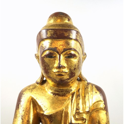 685 - Burmese carved giltwood figure of Buddha, wearing a pleated Sanghati and seated in Vajrasana on a do... 