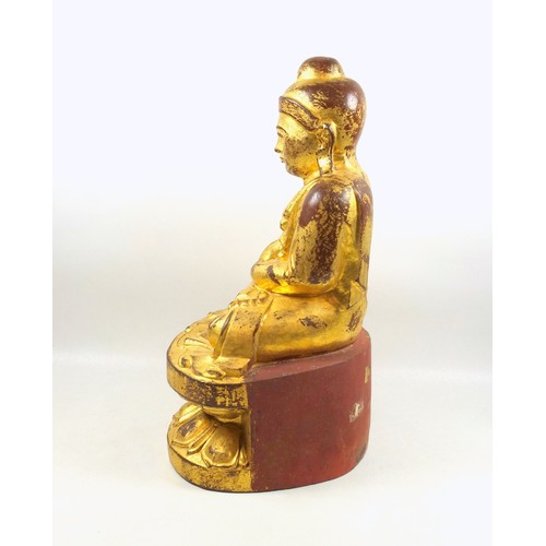 685 - Burmese carved giltwood figure of Buddha, wearing a pleated Sanghati and seated in Vajrasana on a do... 