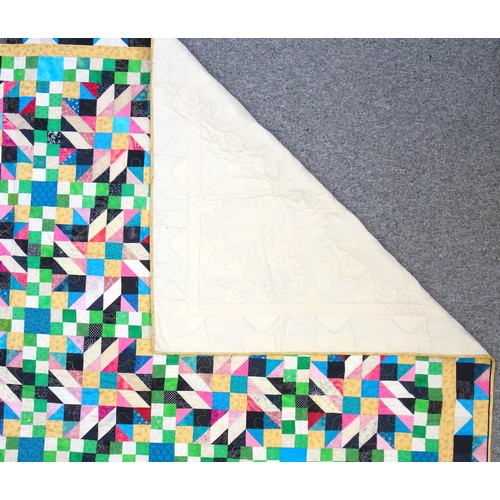 733 - Patchwork quilt, composed of polychrome patterned hexagonal patches sewn onto a brown ground, 233 x ... 