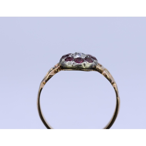 10 - ANTIQUE RUBY AND DIAMOND CLUSTER RING, set with a central diamond of approx. 0.20 ct. surrounded by ... 