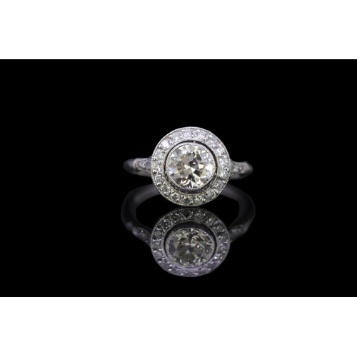 22 - DIAMOND CLUSTER RING, set with a central diamond of approx. 1.32 ct. surrounded by diamonds and diam... 