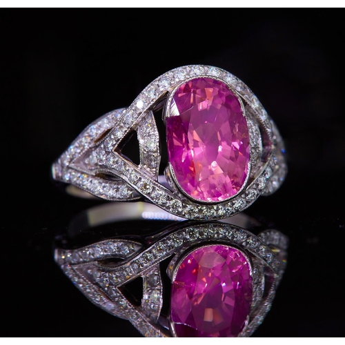 103 - PINK SAPPHIRE AND DIAMOND DRESS RING, set with a central pink sapphire of approx. 3.50 ct. in openwo... 