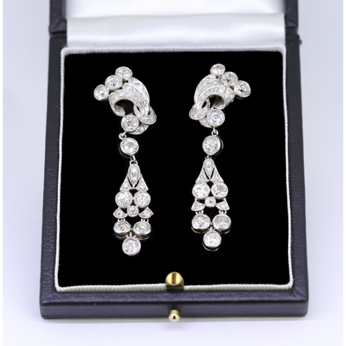 107 - IMPORTANT PAIR OF DIAMOND DROP EARRINGS, of part scrolling openwork design. Set with diamonds totall... 