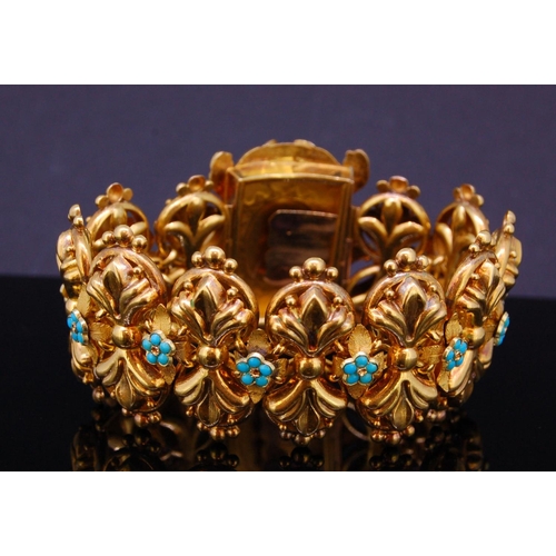 24 - ANTIQUE TURQOISE LINK BRACELET, the links of scrolling design, alternated with a floral shaped turqu... 