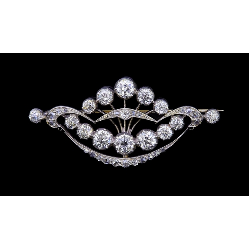 39 - DIAMOND OPENWORK BROOCH, the openwork brooch of part crescent and scroling design, set with diamonds... 