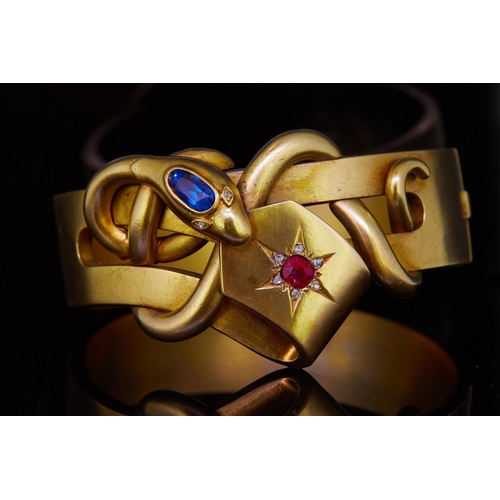 44 - ANTIQUE VICTORIAN SAPPHIRE, RUBY AND DIAMOND SNAKE BANGLE, the top designed as a curled snake holdin... 