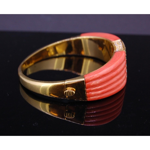 101 - A VINTAGE CORAL AND DIAMOND BANGLE in 18ct yellow gold, the tapering body set with a central square ... 