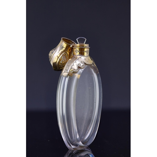 164 - ANTIQUE VICTORIAN ROCK CRYSTAL PERFUME BOTTLE WITH GOLD MOUNTS. The perfume bottle of oval shape, se... 