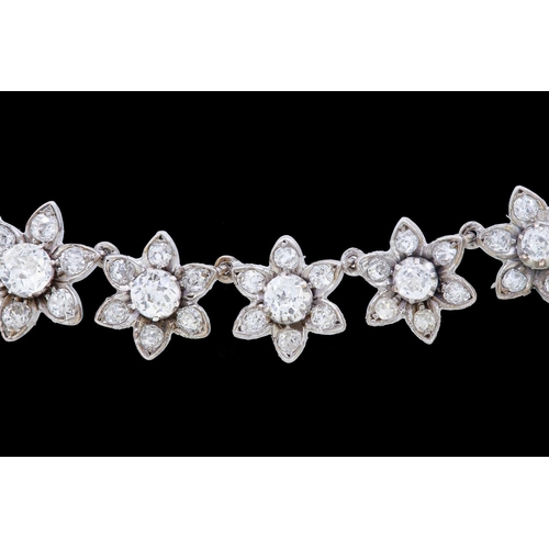 17 - ANTIQUE DIAMOND NECKLACE AND BRACELET, of floral design, set with diamond clusters, totalling approx... 