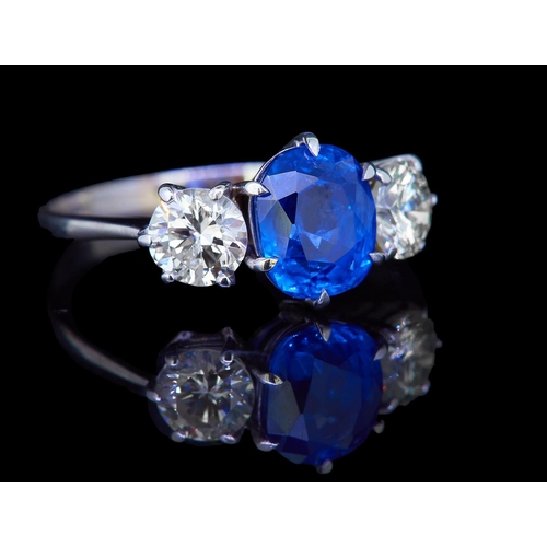 19 - IMPORTANT CERTIFICATED 2.30 CT. CEYLON BLUE SAPPHIRE AND DIAMOND 3-STONE RING, set with a central cu... 