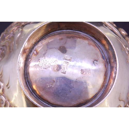 247 - SILVER DRAGON BOWL, decorated all around with a dragon in relief through the waves. With scallobed r... 