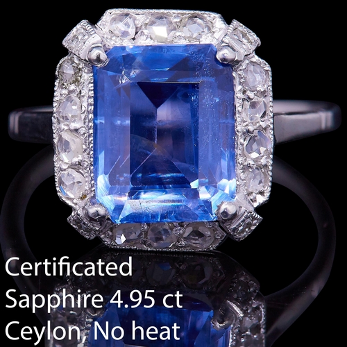 13 - CERTIFICATED 4.95 SAPPHIRE AND DIAMOND CLUSTER RING, set with a central rectangular blue sapphire of... 