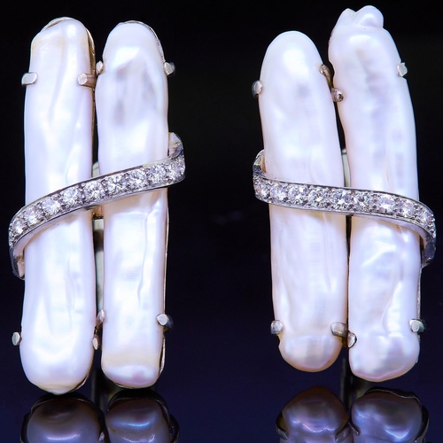 23 - PAIR OF PEARL AND DIAMOND CUFFLINKS, set with 2 long pearls side to side, toppe with a cross diamond... 