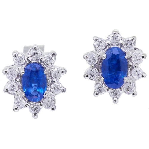 46 - PAIR OF SAPPHIRE AND DIAMOND CLUSTER STUD EARRINGS, set with a central blue sapphire totalling appro... 