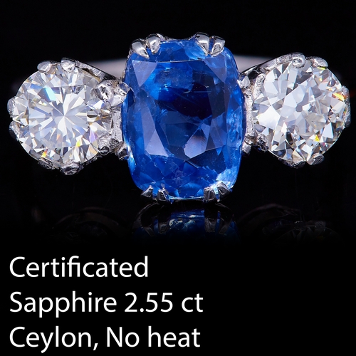 52 - CERTIFICATED SAPPHIRE AND DIAMOND 3-STONE RING, in platinum. Set with a central blue sapphire of 2.5... 