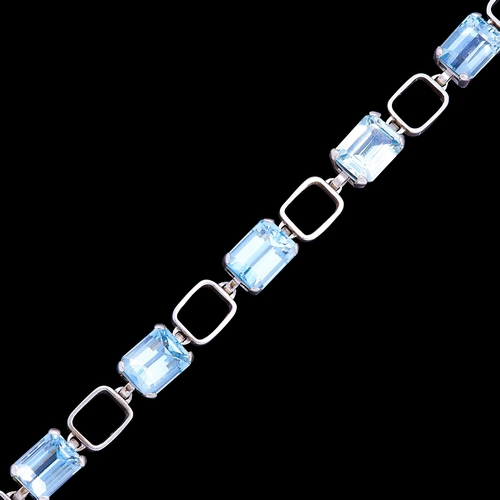 13 - AQUAMARINE LINK BRACELET, in 18 ct. white gold. Set with 7 aquamarines totalling approx. 26.6 ct. L.... 