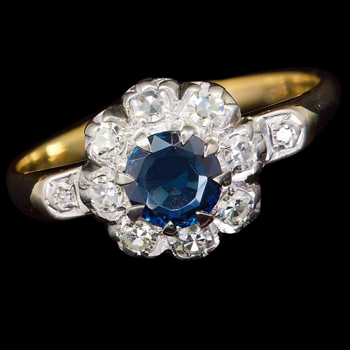 17 - SAPPHIRE AND DIAMOND CLUSTER RING, in 18 ct. gold. Set with a central blue sapphire of approx. 0.61 ... 