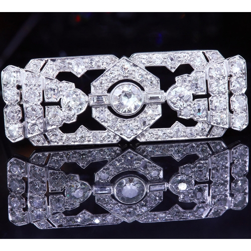 46 - ART-DECO DIAMOND BROOCH, of openwork geometrical design, set with a larger central diamond and set t... 