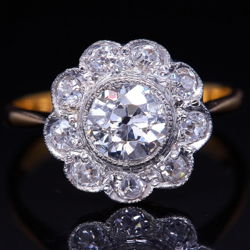 49 - DIAMOND DAISY CLUSTER RING, set with a central diamond surrounded by diamonds, totalling approx. 1.1... 